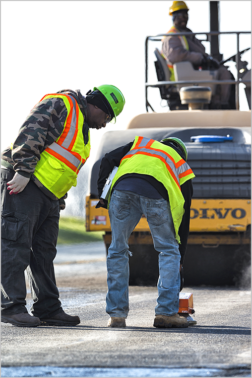 Workers performing maintenance on a road