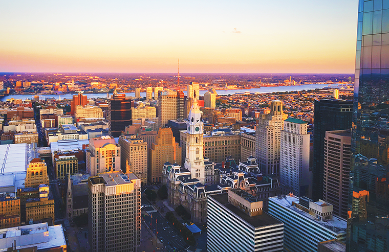 A photo of Center City East looking over the buildings toward the Delaware River at dusk