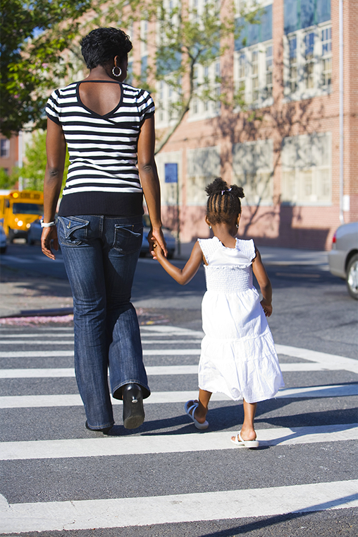 Woman and child crossing the street