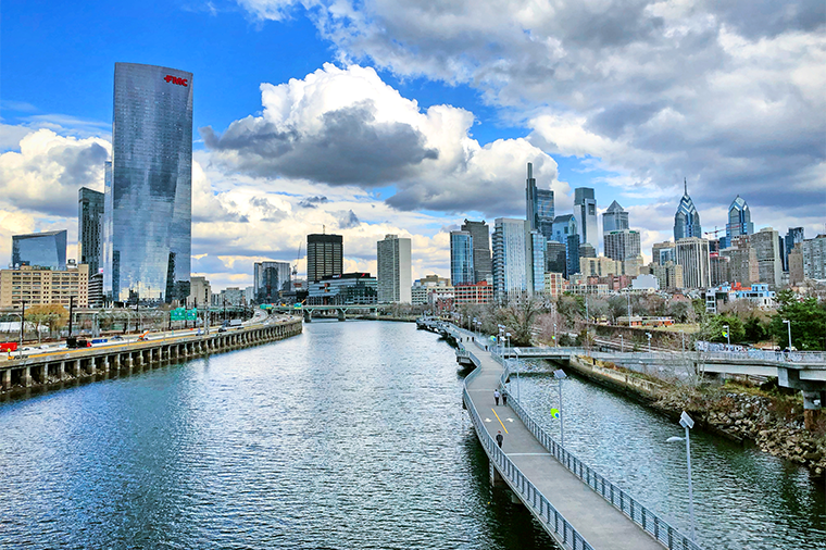 A photo of a cloudy blue sky above the Schuylkill River in Philadelphia