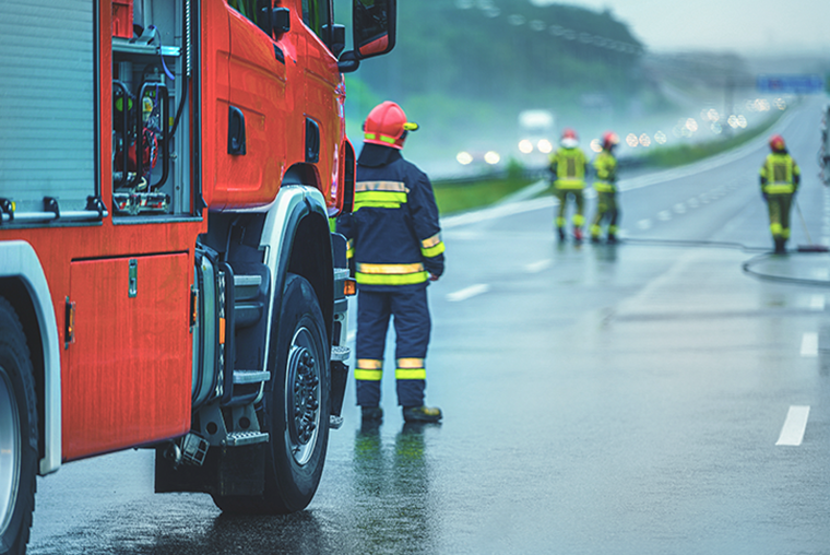 A photograph of first responders on the scene of an incident on a highway