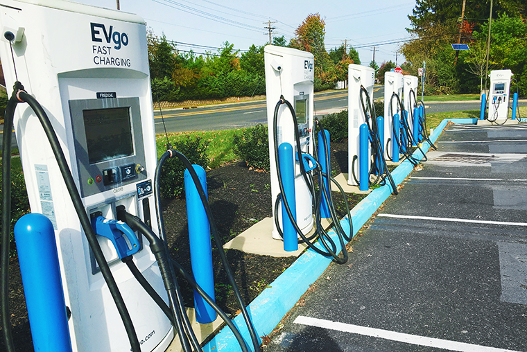 A photo of a parking lot featuring electric vehicle charging stations