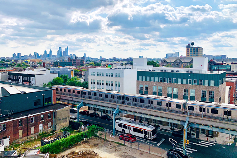Photograph of Philadelphia skyline in the distance, with elevated train in the foreground