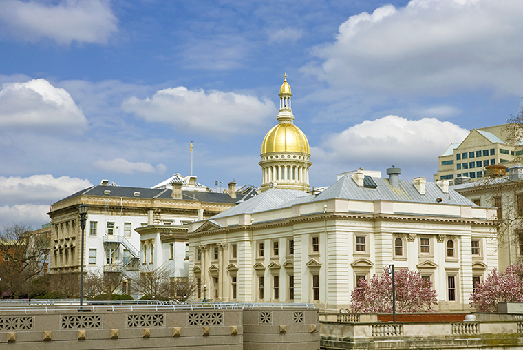 A photo featuring the gold dome of Trenton's city hall