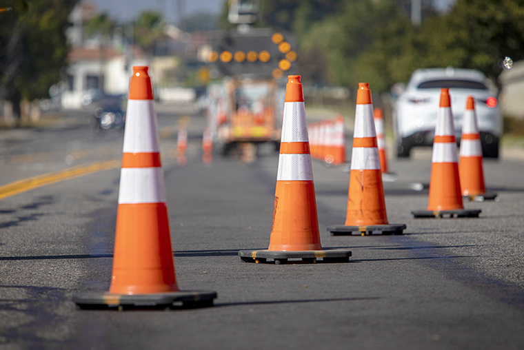 A photo of orange cone closing off a lane of traffic for construction